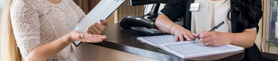 A woman distributing papers on the counter