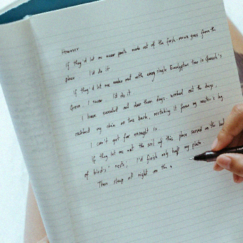 Close up photo of a notebook and a person using GRE analytical writing template