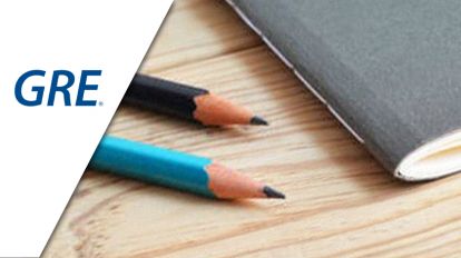 Two pencils and one notebook on top of a table