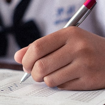Close up image of a student answering an exam