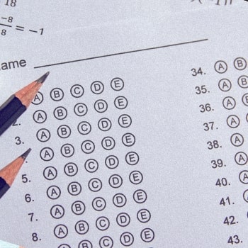 Top view of an answer sheet with a pencil above