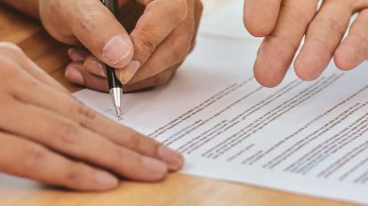 A person signing an important document