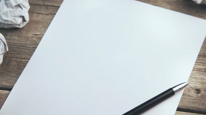 A scratch paper for GRE with pen surrounded by crumpled sheets
