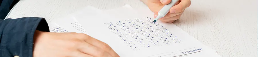 hand view of a student doing his test paper