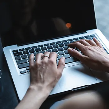 A person typing on a laptop