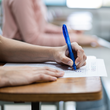 student writing on a sheet