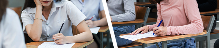 Student in uniform and in casual attire answering an examination
