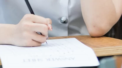 Student answering an examination inside the classroom