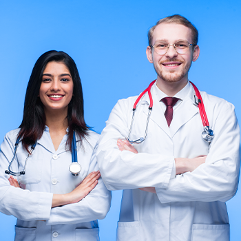 male and female doctor standing with arms crossed