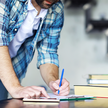 man writing on a paper