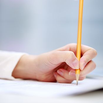hand view of a person writing on a paper