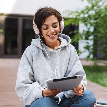 female student on her tablet outdoors