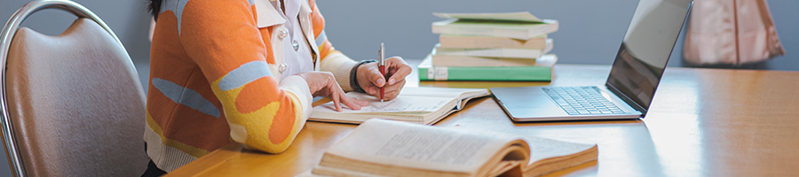 female reading books and working