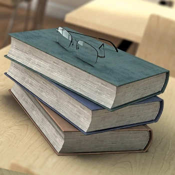 Stack of books with eyeglasses above