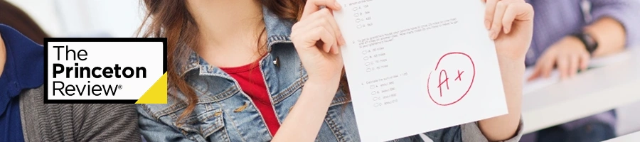 A student showing off her grade in front of the camera